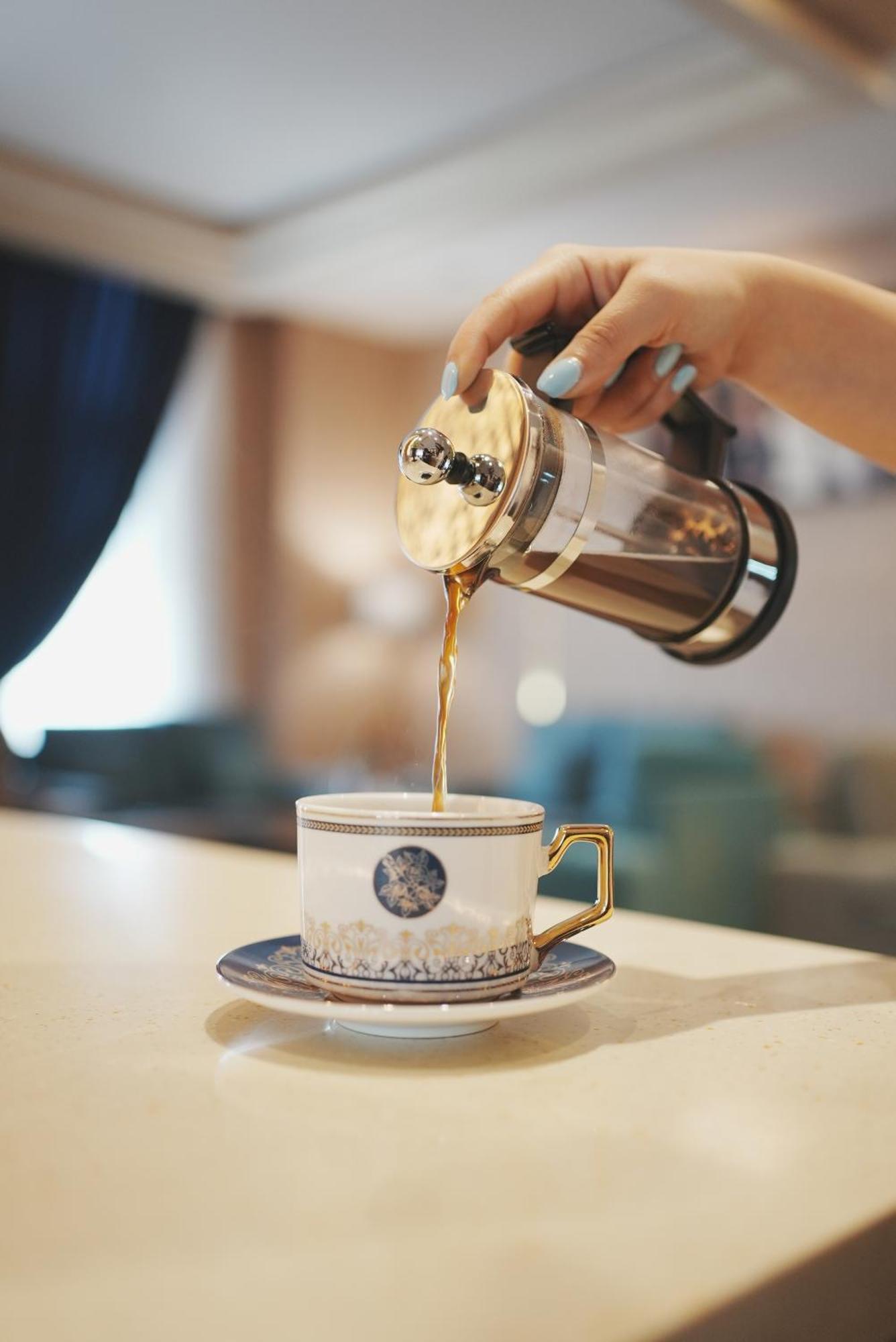 Thousand Nights Hotel Амман Экстерьер фото Coffee being poured from a French press