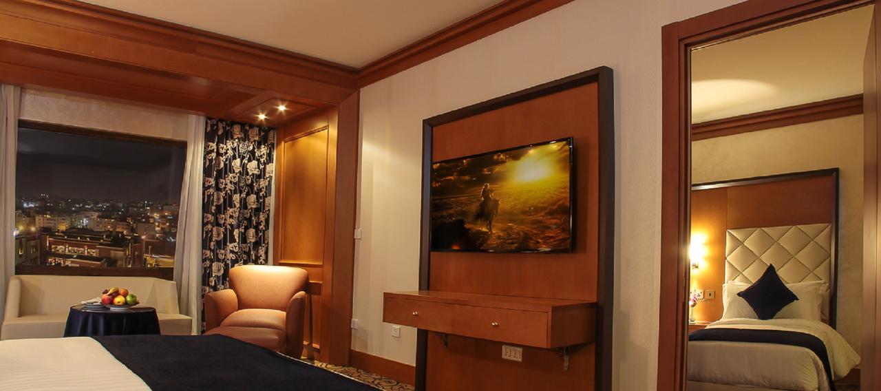 Thousand Nights Hotel Амман Экстерьер фото A television in a hotel room